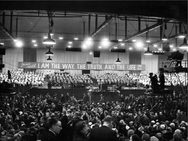 HeraldScotland: Crowds await American evangelist Billy Graham at Kelvin Hall in 1955. Photo: Newsquest