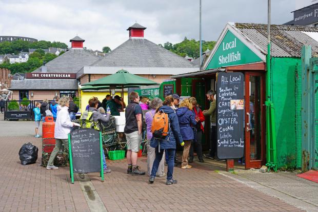 HeraldScotland: OBAN, SCOTLAND -15 JUL 2017- The landmark Oban Seafood Hut (Green Shack) next to the CalMac ferry terminal in the harbor town of Oban, in Argyll and Bute, known as the seafood capital of Scotland.; Shutterstock ID 690406891; Purchase Order: Herald