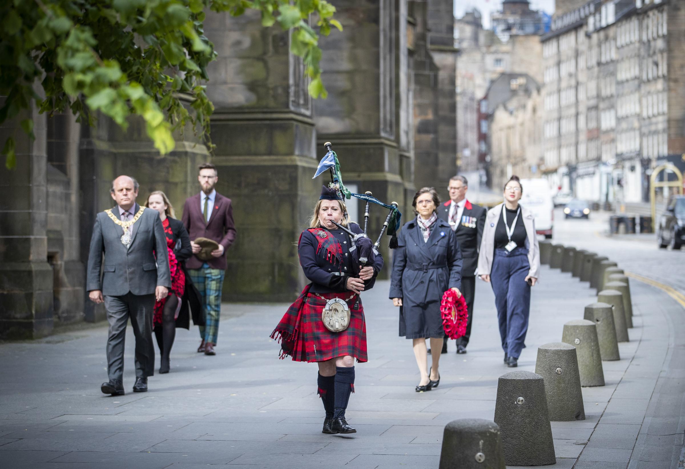 Piper Louise Marshall plays the pipers march Heroes of St Valery and leads the procession down Edinburghs Royal Mile in June 2020.