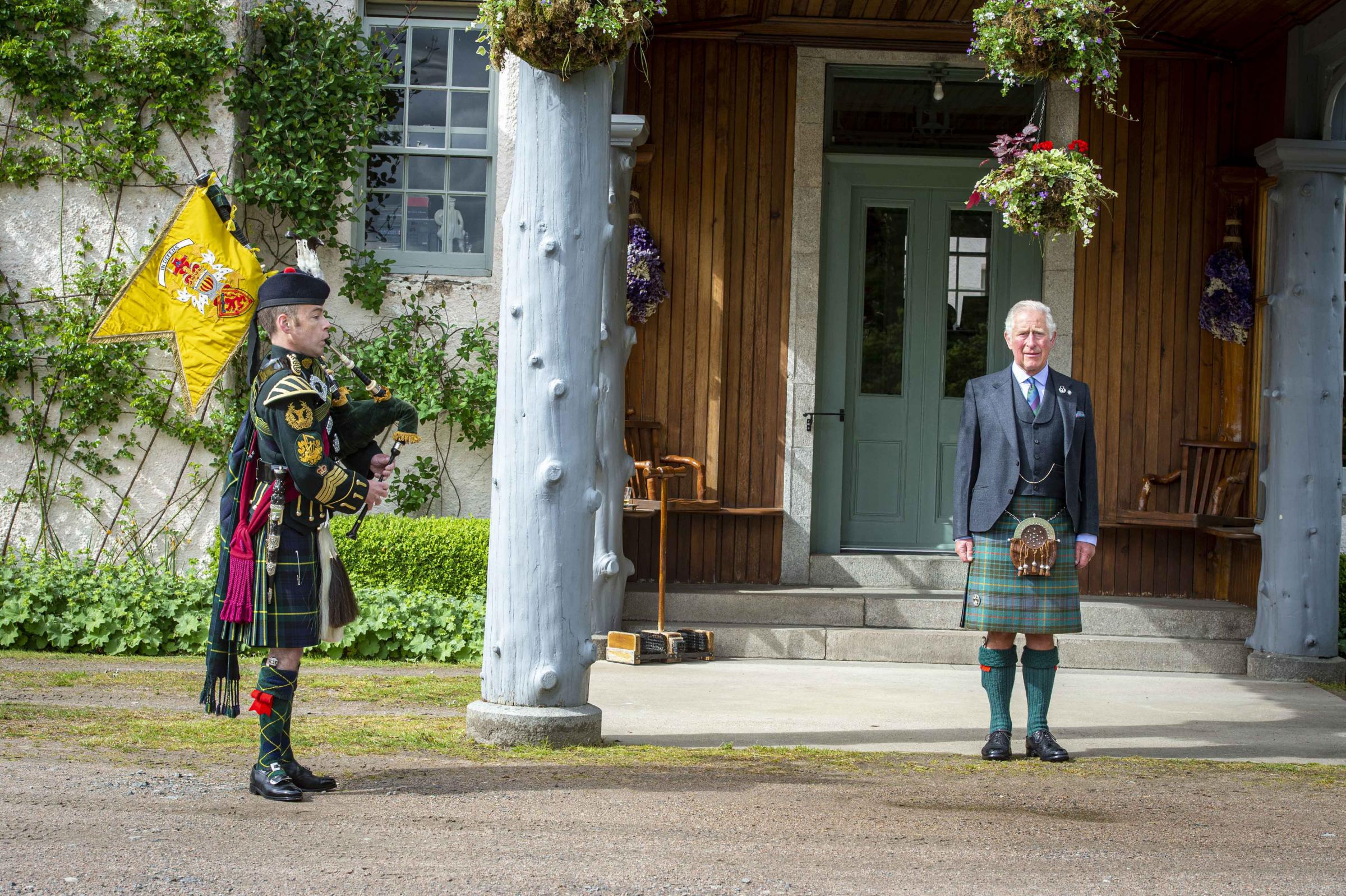 HRH, the Prince of Wales taking a salute as a piper plays during a St Valery commemoration at his Birkhall residence in Scotland. Photo credit should read: Mark Owens/Poppyscotland.