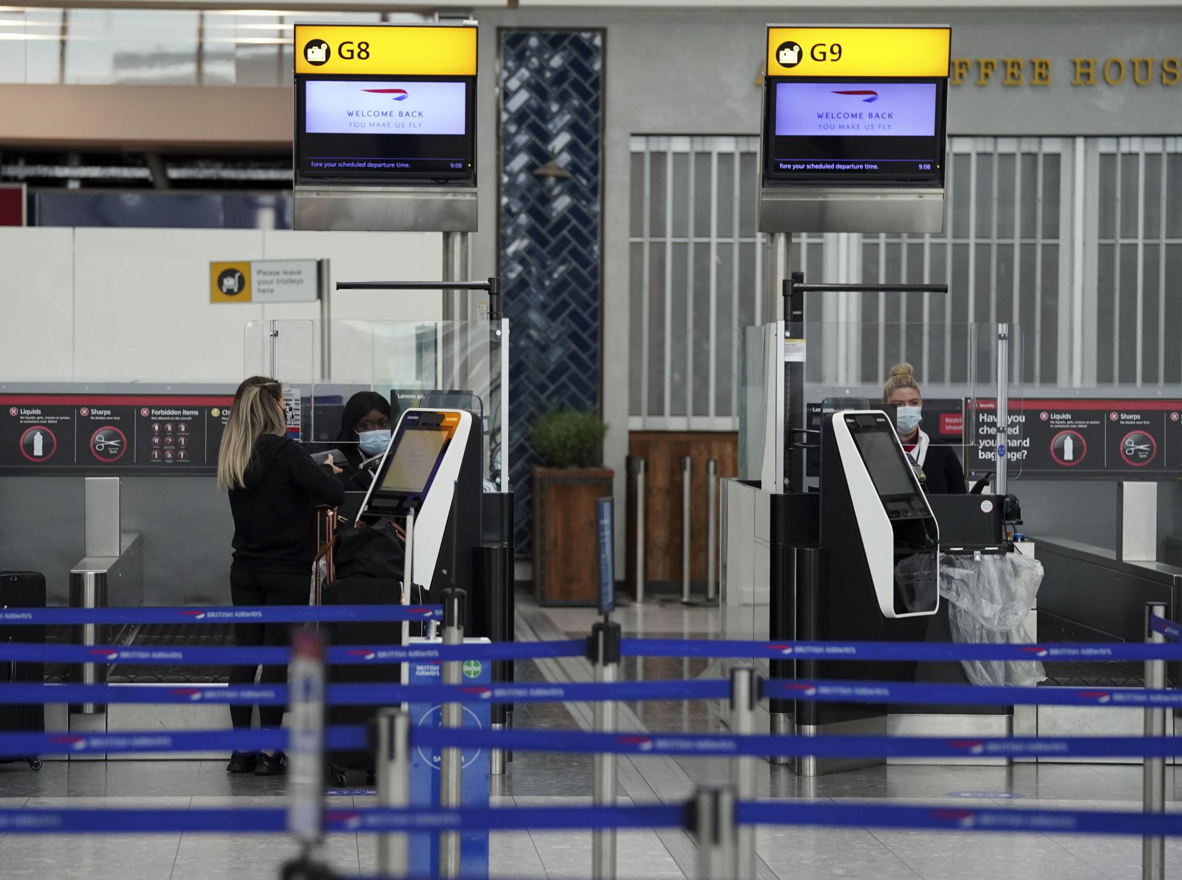 A passenger checks into her flight in Terminal 5 at Heathrow Airport Picture: Steve Parsons/PA Wire 
