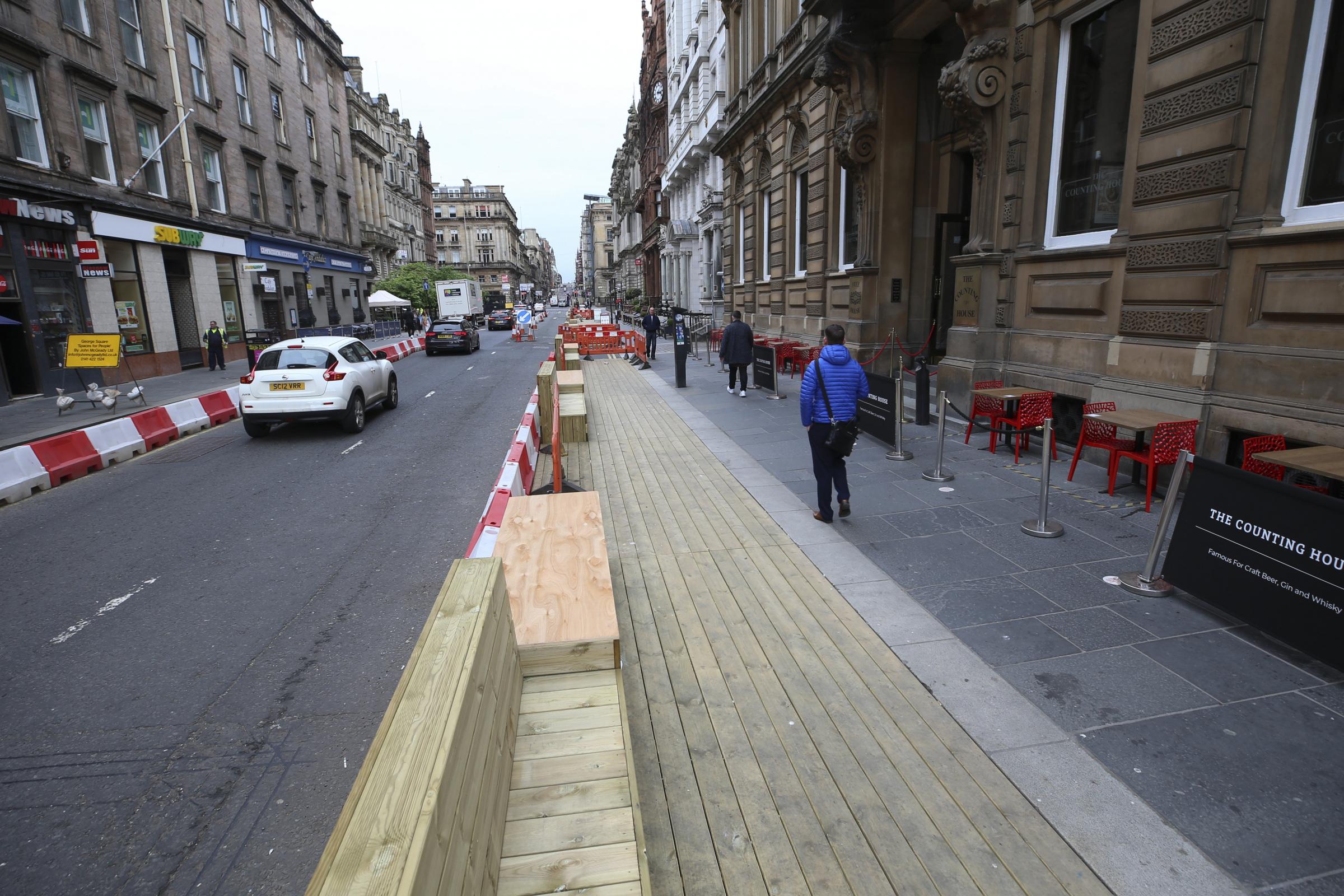 Decking and wooden seating built along St Vincent Place in Glasgow as part of Spaces for People. Photo by Gordon Terris.