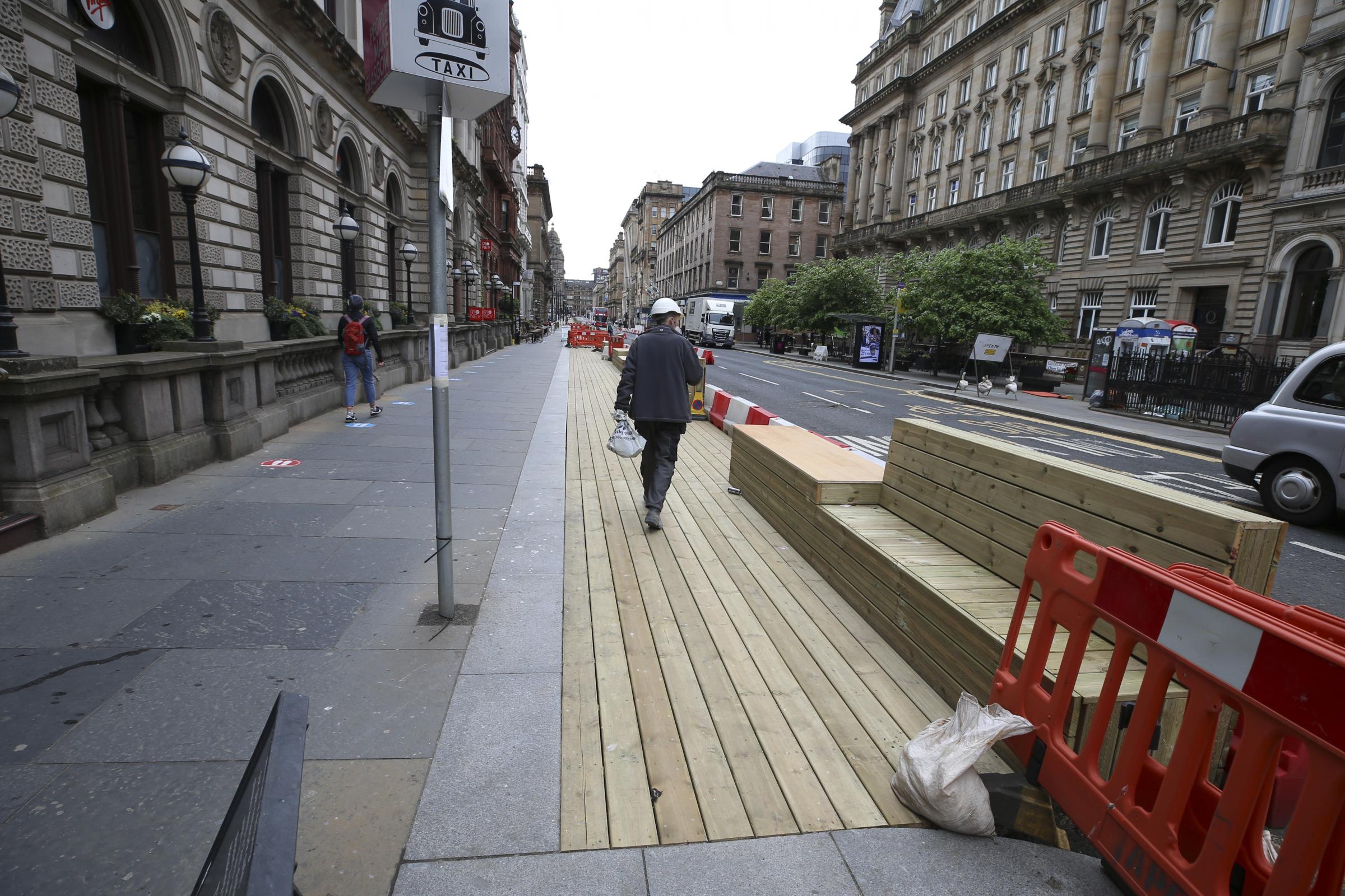 Decking and wooden seating built along St Vincent Place in Glasgow as part of the Spaces for People initiative