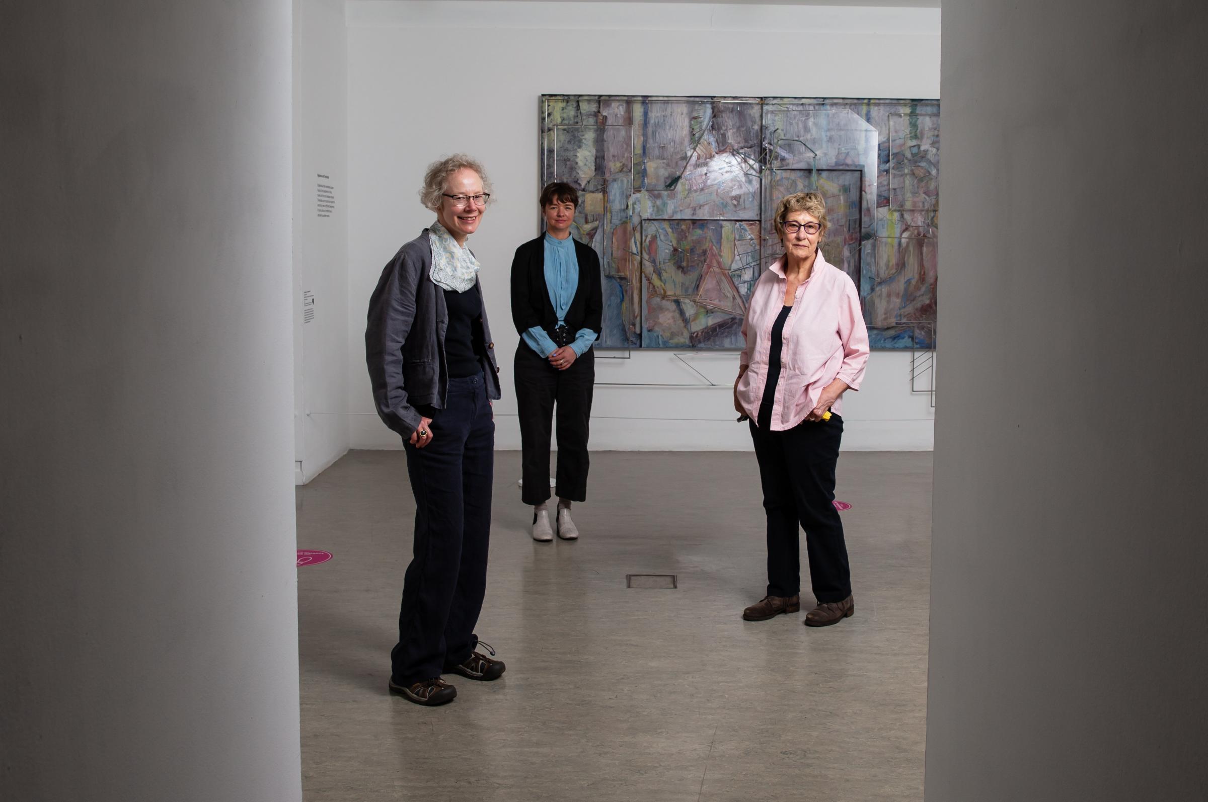 Three of the artists whose work is on display, they are from left - Jo Ganter, Kate V Robertson and Jacki Parry. The work in the background is Double Son of Rubble by artist Sara Barker. Photograph by Colin Mearns.