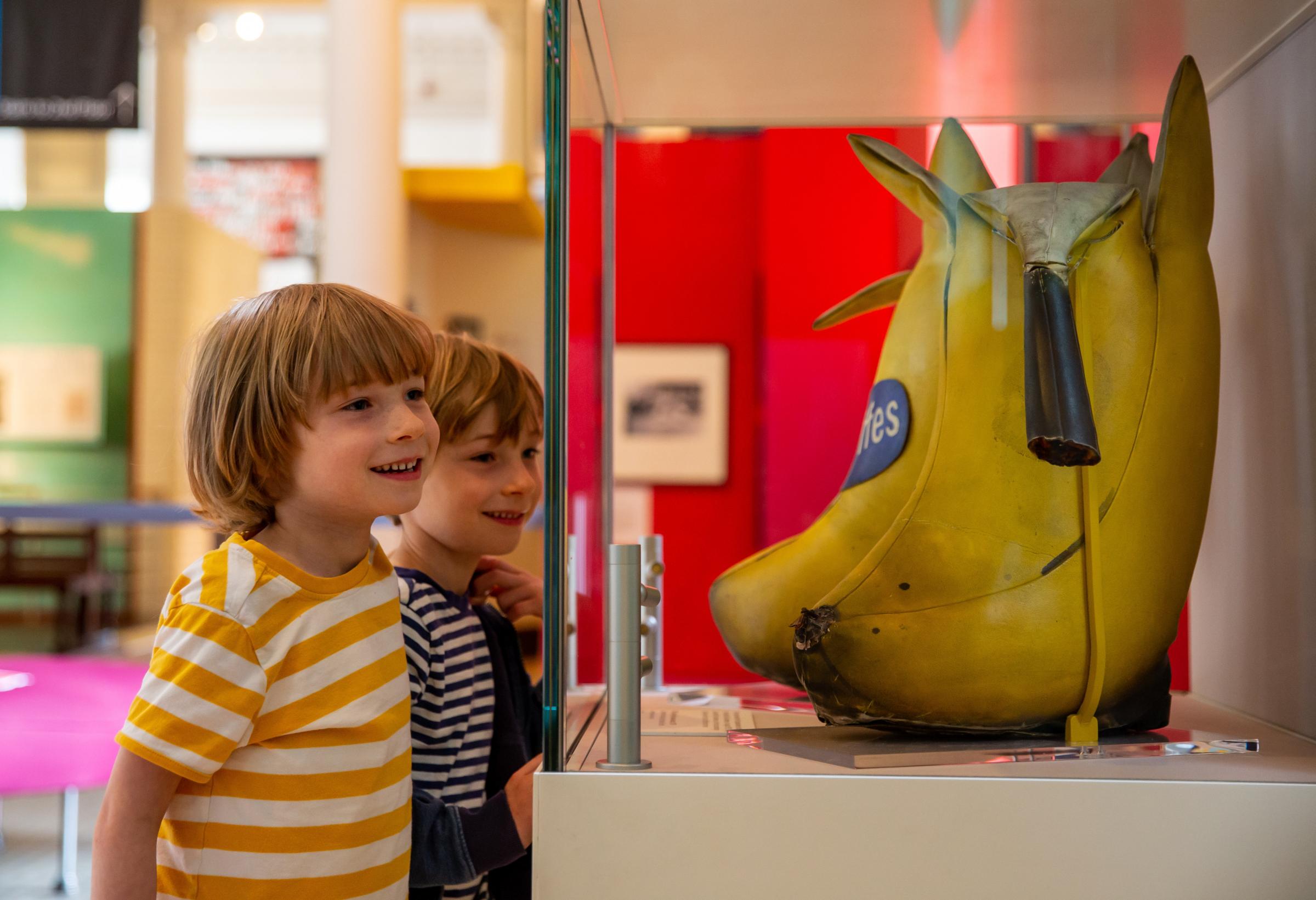Five-yearold twin brothers Elil, left and Llewyn McGreevy-McCann looking at Billy Connollys banana boots that were designed and made by the artist Edmund Smith in 1975.. Photograph by Colin Mearns.
