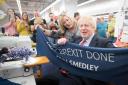 Prime Minister Boris Johnson holds up a banner with the words 'Get Brexit Done' during a visit to the John Smedley Mill, while election campaigning in Matlock, Derbyshire. PA Photo. Picture date: Thursday December 5, 2019. See PA story POLITICS E