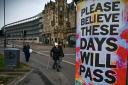 GLASGOW, SCOTLAND - APRIL 09: Members of the public walk past new posters placed around the city center on April 9, 2020 in Glasgow, Scotland. There have been around 60,000 reported cases of coronavirus (COVID-19) in the United Kingdom and 7,000 deaths.
