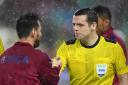 Douglas Ross shakes hands with Lionel Messi while officiating Barcelona's game against Olympiacos in 2017