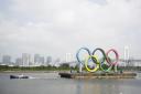 A tugboat moves a symbol installed for the Olympic and Paralympic Games Tokyo 2020 on a barge moved away from its usual spot off the Odaiba Marine Park in Tokyo Picture: HIRO KOMAE/AP.