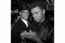 World heavyweight boxing champion Muhammad Ali, right, is shown with black Muslim leader Malcolm X outside the Trans-Lux Newsreel Theater in New York, after viewing the screening of a film about Ali's title fight with Sonny Liston, in this March 1, 19