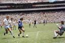 Argentinian forward Diego Armando Maradona (3rd L) runs past English defender Terry Butcher (L) on his way to dribbling goalkeeper Peter Shilton (R) and scoring his second goal, or goal of the century, during the World Cup quarterfinal soccer match