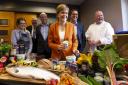 First Minister Nicola Sturgeon holds a tub of locally-produced ice cream as she meets representatives from Taste of Arran at the Auchrannie spa resort in Brodick, on the Isle of Arran, in  2018