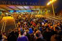 Fans leave Wembley Stadium after the Euro 2020 match between England and Scotland
