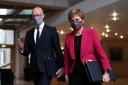 Nicola Sturgeon and John Swinney arrive for First Minister's Questions in the debating chamber of the Scottish Parliament. File Photo PA.