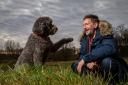 Garry Scott with his dog Holly, a Labradoodle. Picture: Colin Mearns