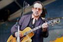 Elvis Costello performs at the New Orleans Jazz & Heritage Festival Saturday, April 30, 2005, in New Orleans. (AP Photo/Burton Steel).