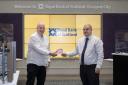 Senior Branch Manager at Royal Bank of Scotland,  Nim Roy, hands over the special edition £50 note to the photography competition winner John Dyer.