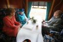 Queen Elizabeth pictured in September 2015 with her late husband, Prince Philip, and Nicola Sturgeon, as they travel on a steam train to inaugurate the new £294 million Scottish Borders Railway.  Photo PA.