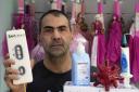 Giorgos Souliotis, owner of an online Easter candle store and a seasonal goods store, poses with a candle that resemble a COVID-19 test kit in Athens, Greece, on Tuesday, April 19, 2022. Greeks celebrate Easter with other Orthodox Christians on Sunday,