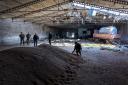 NOVOVORONTSOVKA, UKRAINE - MAY 06: Local government officials and  Ukrainian soldiers inspect a wheat grain warehouse earlier shelled by Russian forces on May 06, 2022 near the frontlines of Kherson Oblast in Novovorontsovka, Ukraine. Russia has been