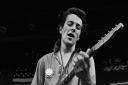 Joe Strummer, of The Clash, plays during their 1979 
