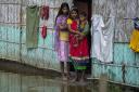 A flood affected family waits for the help at marooned Tarabari village, west of Gauhati, in the northeastern Indian state of Assam, Monday, June 20, 2022. Authorities in India and Bangladesh are struggling to deliver food and drinking water to hundreds