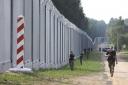 Polish border guards patrol the area of a newly built metal wall on the border between Poland and Belarus, near Kuznice, Poland, Thursday, June 30, 2022. A year after migrants started crossing into the European Union from Belarus to Poland, Polish Prime