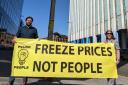 Power to the People members Matt Kerr and Frances Curran hold a banner reading 'Freeze prices, not people'.