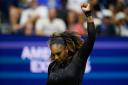 Serena Williams holds her arm aloft during her victory over Danka Kovinic