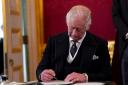 King Charles III signs an oath to uphold the security of the Church in Scotland during the Accession Council at St James's Palace, London, last Saturday, where he was formally proclaimed monarch.