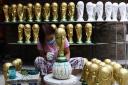 A Qatari woman makes replica World Cup trophies