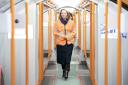 Transport minister Jenny Gilruth walking through one of the new subway trains at the SPT depot in Govan, Glasgow.
