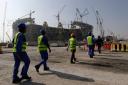 Construction workers walk to the Lusail Stadium in Qatar