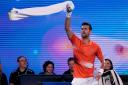 Novak Djokovic dances during his practice match against Nick Kyrgios