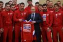 Russian President Vladimir Putin with athletes going to the Winter Olympics to compete under a neutral flag