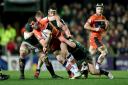 Emiliano Boffelli is brought down by Leicester Tigers players