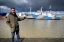 Captain Lockhart Maclean standing in front of the John Paul Dejoria, former Scottish Fisheries Protection vessel now fighting whaling