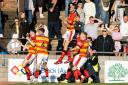 Partick Thistle's players celebrate Jack McMillan's opener in their romp over Ayr United.