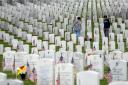 People walk among headstones as they visit Section 60 at Arlington National Cemetery on Memorial Day (Alex Brandon/AP)
