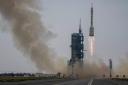 A Long March rocket carrying a crew of Chinese astronauts in a Shenzhou-16 spaceship lifts off (Mark Schiefelbein/AP)