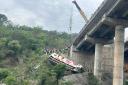 The bus skidded off a bridge (Channi Anand/AP)