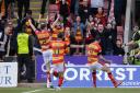 Brian Graham celebrates with the Thistle fans after lashing in his side's second goal