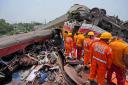 Rescuers work at the site of passenger trains that derailed in Balasore district