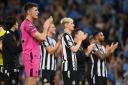 Newcastle players clap their fans at the Etihad