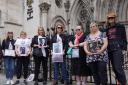 Campaigners holding up pictures of their deceased relatives outside the Royal Courts of Justice in London when the Cabinet Office brought a challenge over the UK Covid-19 Inquiry's request for materials. The Scottish Covid Inquiry is just beginning.