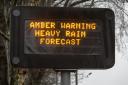 An amber weather warning sign on the motorway in Dumfries, Scotland