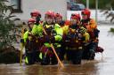 A rescue team makes their way through the flood waters on October 20, 2023 in Brechin Scotland