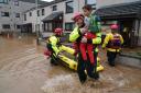 Members of the emergency services help local residents to safety in Brechin, Scotland (Andrew Milligan/PA)