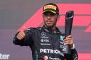 Mercedes driver Lewis Hamilton, of Britain, celebrates on the podium after the Formula One U.S. Grand Prix auto race at Circuit of the Americas, Sunday, Oct. 22, 2023, in Austin, Texas. (AP Photo/Darron Cummings)