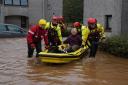 Members of the emergency services help local residents to safety in Brechin